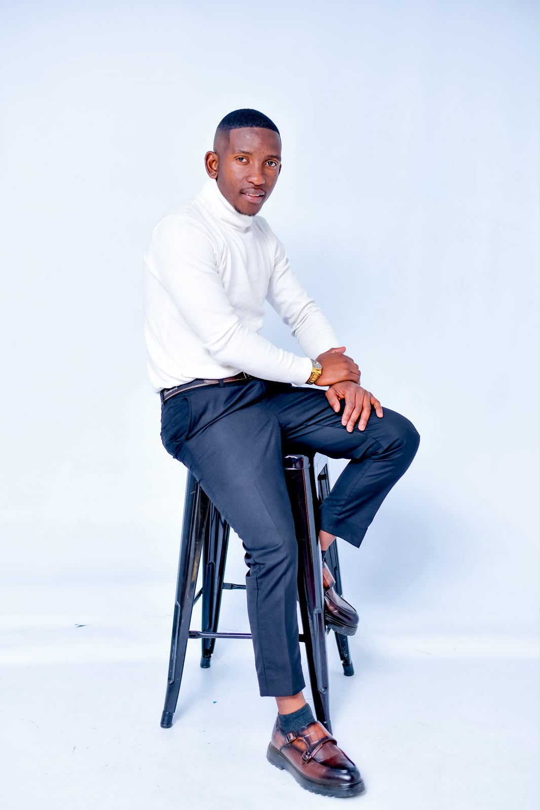 Mr Brendan seated in professional attire